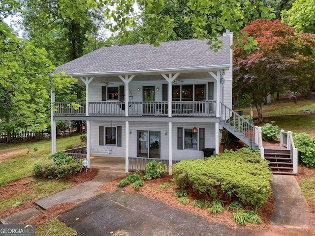 2309 Ridgecrest Cir, Hiawassee, GA 30546 - view of front of house with a porch, a balcony, stairs, a ceiling fan, and roof with shingles