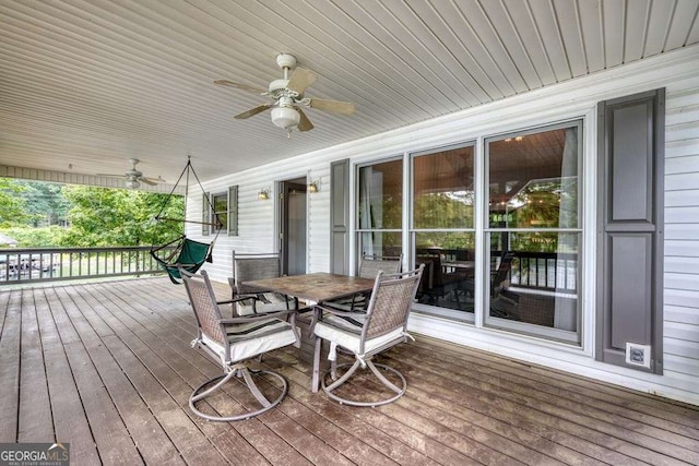 2309 Ridgecrest Cir, Hiawassee, GA 30546 - wooden deck with ceiling fan and outdoor dining space