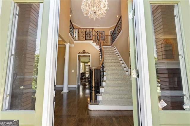 3410 Kates Way, Duluth, GA 30097 - foyer entrance featuring ornate columns, stairway, a chandelier, wood finished floors, and a towering ceiling
