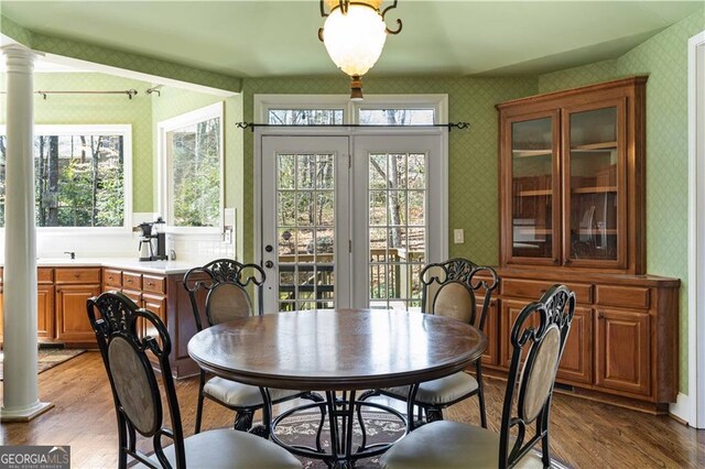 3410 Kates Way, Duluth, GA 30097 - dining room featuring wallpapered walls, ornate columns, and light wood finished floors