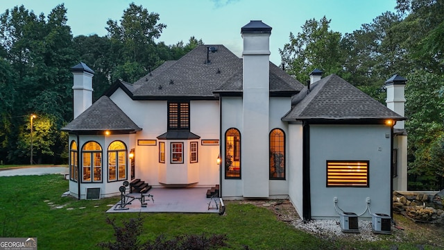 2878 Heather Row Rdg SW, Lilburn, GA 30047 - back of property featuring a chimney, a shingled roof, stucco siding, and a yard