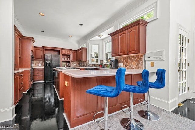 2878 Heather Row Rdg SW, Lilburn, GA 30047 - kitchen featuring a peninsula, tasteful backsplash, dark wood-style floors, light countertops, and ornamental molding