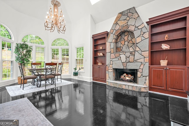 2878 Heather Row Rdg SW, Lilburn, GA 30047 - living room with baseboards, a stone fireplace, high vaulted ceiling, a chandelier, and wood finished floors