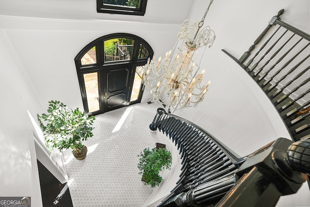 2878 Heather Row Rdg SW, Lilburn, GA 30047 - stairway featuring a towering ceiling, carpet flooring, and a chandelier