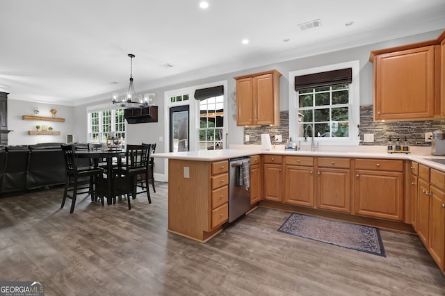 285 Finsbury Park Ct, Suwanee, GA 30024 - kitchen with stainless steel dishwasher, a peninsula, tasteful backsplash, wood finished floors, and ornamental molding