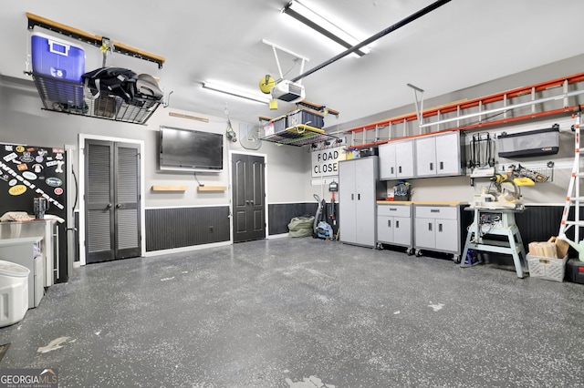 285 Finsbury Park Ct, Suwanee, GA 30024 - garage with a garage door opener and a wainscoted wall