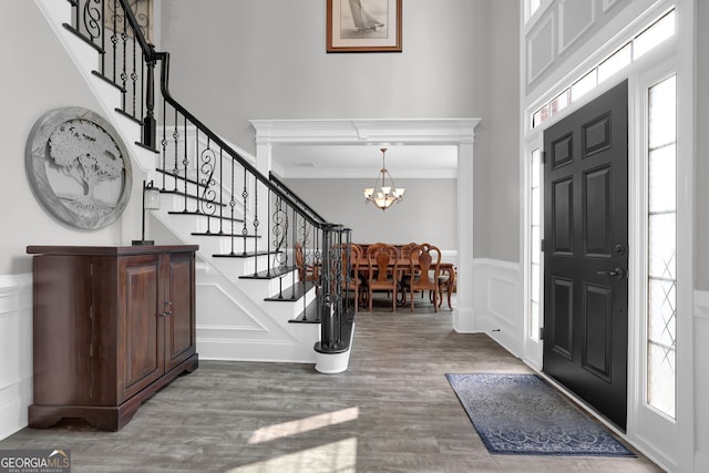 285 Finsbury Park Ct, Suwanee, GA 30024 - entrance foyer featuring a decorative wall, a chandelier, stairs, a wainscoted wall, and wood finished floors