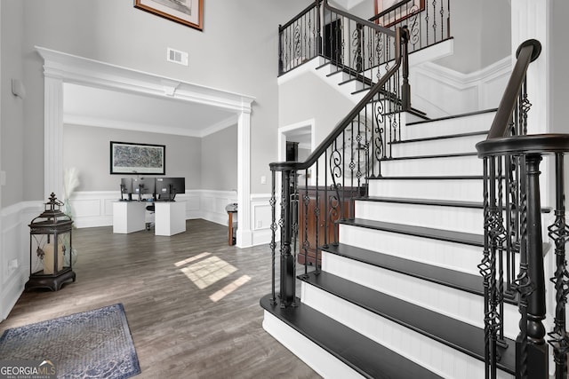 285 Finsbury Park Ct, Suwanee, GA 30024 - entrance foyer with wainscoting, stairs, a decorative wall, decorative columns, and crown molding