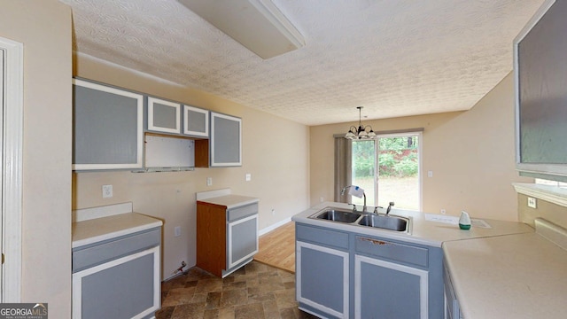 176 Silver Fox Trl, Dallas, GA 30157 - kitchen featuring a sink, stone finish flooring, a peninsula, a textured ceiling, and light countertops