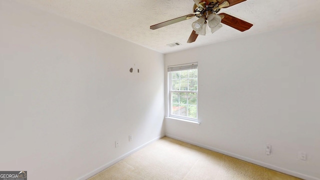 176 Silver Fox Trl, Dallas, GA 30157 - spare room with baseboards, a ceiling fan, a textured ceiling, and light colored carpet