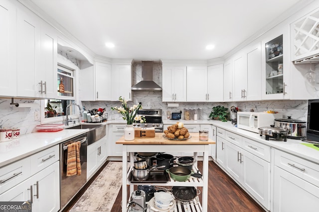 6628 Londonderry Dr, Morrow, GA 30260 - kitchen featuring wall chimney range hood, stainless steel appliances, light countertops, tasteful backsplash, and recessed lighting