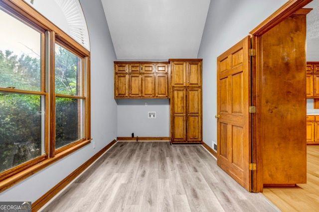 362 Clyde Ct, Mcdonough, GA 30252 - washroom featuring light wood-style flooring, cabinet space, baseboards, and hookup for a washing machine