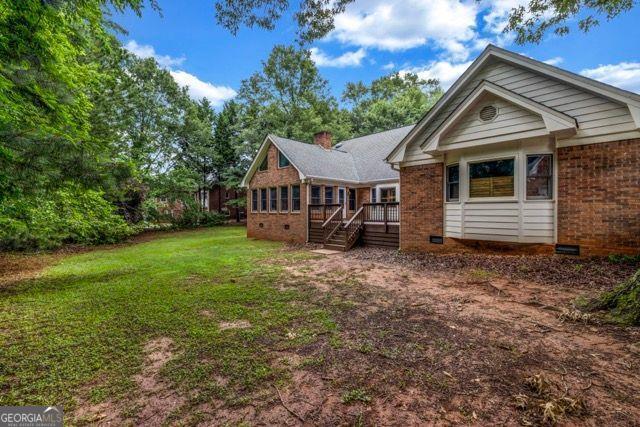 362 Clyde Ct, Mcdonough, GA 30252 - rear view of property featuring brick siding, a lawn, and crawl space