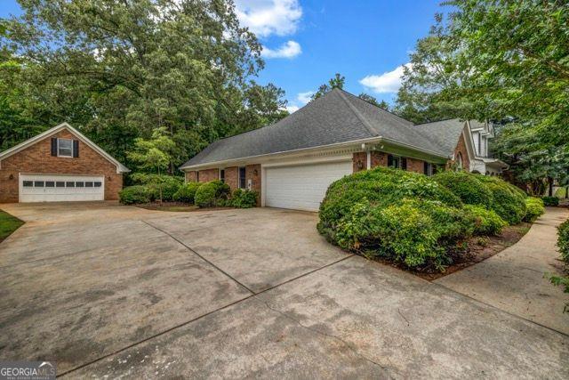 362 Clyde Ct, Mcdonough, GA 30252 - view of home's exterior with a garage