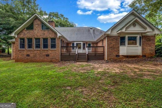 362 Clyde Ct, Mcdonough, GA 30252 - back of property featuring crawl space, a wooden deck, a lawn, brick siding, and a chimney