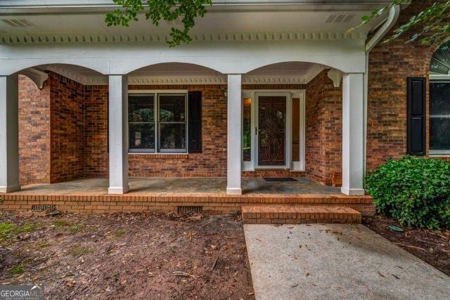 362 Clyde Ct, Mcdonough, GA 30252 - entrance to property featuring a porch and brick siding