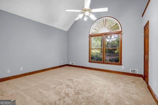 362 Clyde Ct, Mcdonough, GA 30252 - carpeted spare room with lofted ceiling, a ceiling fan, and baseboards