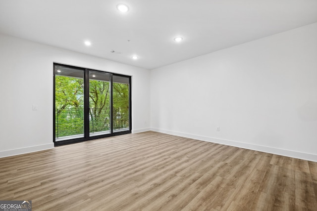 112 Rogers St NE Unit 304, Atlanta, GA 30317 - unfurnished room with light wood-type flooring, recessed lighting, and baseboards