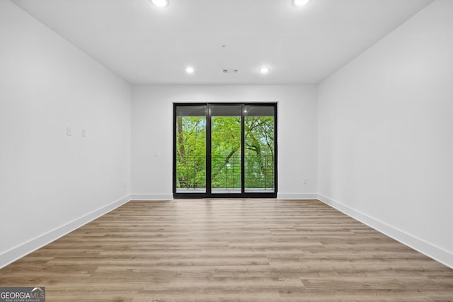 112 Rogers St NE Unit 304, Atlanta, GA 30317 - spare room featuring recessed lighting, baseboards, and light wood-style flooring