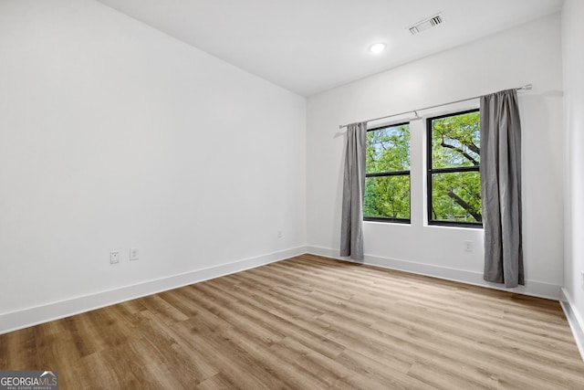 112 Rogers St NE Unit 304, Atlanta, GA 30317 - unfurnished room featuring light wood finished floors, baseboards, and recessed lighting