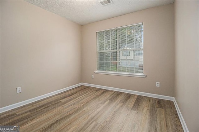 1501 Buckingham Pl, Stockbridge, GA 30281 - empty room featuring wood finished floors and a textured ceiling
