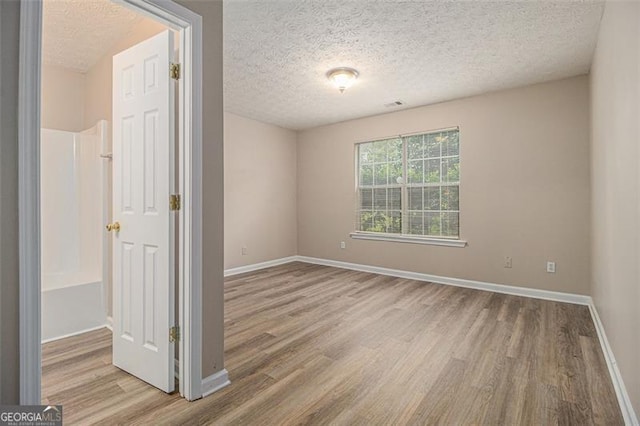 1501 Buckingham Pl, Stockbridge, GA 30281 - unfurnished room featuring wood finished floors and a textured ceiling