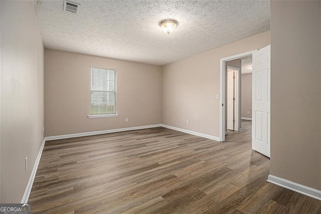 1501 Buckingham Pl, Stockbridge, GA 30281 - unfurnished room with wood finished floors and a textured ceiling