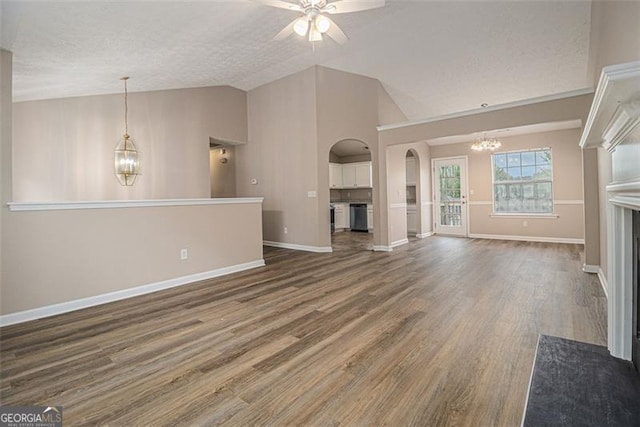 1501 Buckingham Pl, Stockbridge, GA 30281 - unfurnished living room featuring a chandelier, arched walkways, a ceiling fan, lofted ceiling, and a textured ceiling