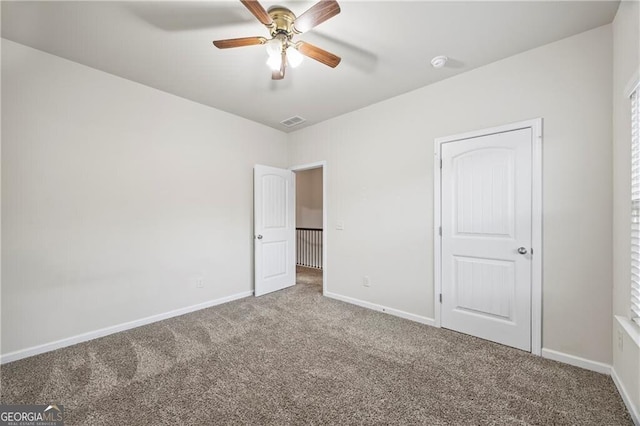 303 Orange Cir, Dawsonville, GA 30534 - unfurnished bedroom featuring carpet, baseboards, and a ceiling fan