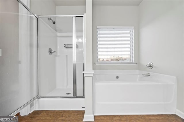 303 Orange Cir, Dawsonville, GA 30534 - full bath with a shower stall, a bath, and wood finished floors