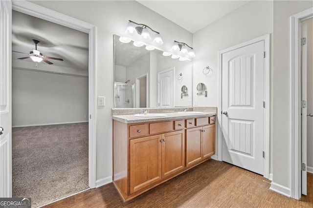 303 Orange Cir, Dawsonville, GA 30534 - full bath with a shower stall, a ceiling fan, double vanity, wood finished floors, and baseboards
