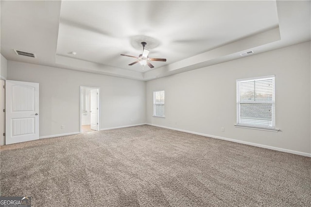 303 Orange Cir, Dawsonville, GA 30534 - empty room with a tray ceiling, carpet, ceiling fan, and baseboards
