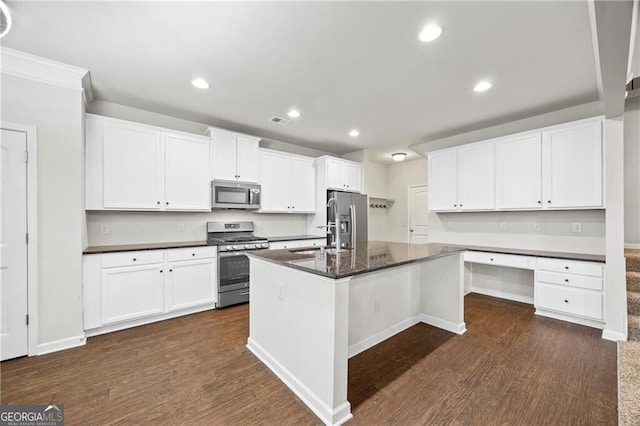 303 Orange Cir, Dawsonville, GA 30534 - kitchen with appliances with stainless steel finishes, dark wood-style flooring, recessed lighting, white cabinetry, and a kitchen island with sink