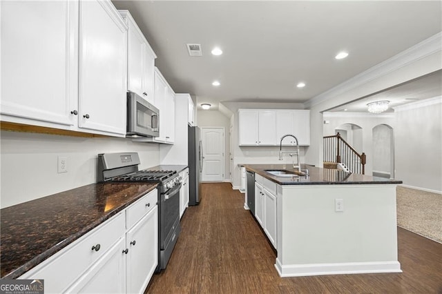 303 Orange Cir, Dawsonville, GA 30534 - kitchen featuring appliances with stainless steel finishes, a sink, arched walkways, white cabinetry, and dark wood-type flooring