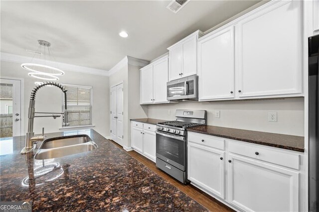 303 Orange Cir, Dawsonville, GA 30534 - kitchen featuring appliances with stainless steel finishes, a sink, crown molding, white cabinets, and dark wood-style flooring