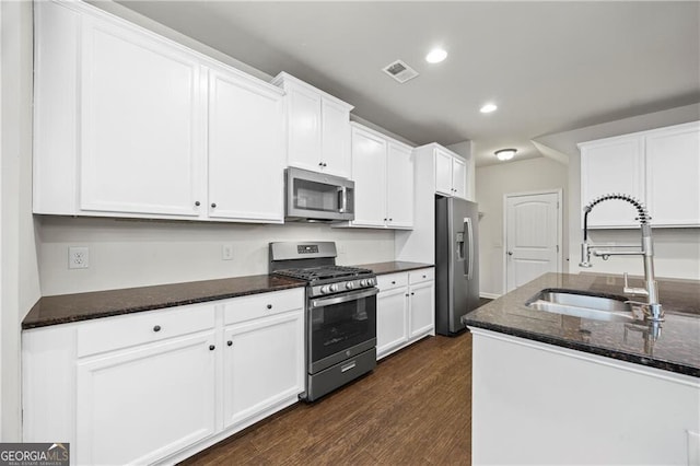 303 Orange Cir, Dawsonville, GA 30534 - kitchen featuring appliances with stainless steel finishes, a sink, dark wood-style floors, recessed lighting, and white cabinets