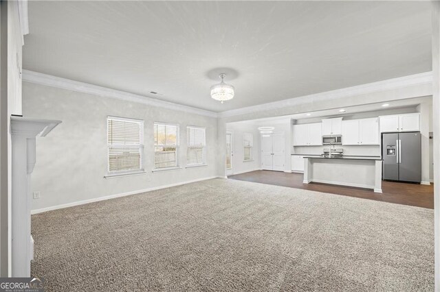 303 Orange Cir, Dawsonville, GA 30534 - unfurnished living room with crown molding, dark colored carpet, baseboards, and recessed lighting