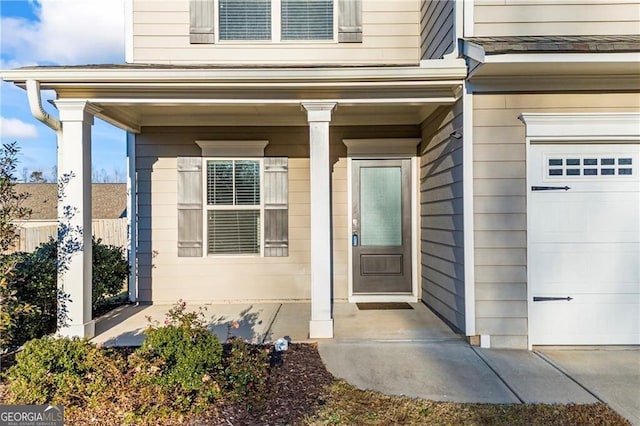 303 Orange Cir, Dawsonville, GA 30534 - entrance to property featuring covered porch and a garage