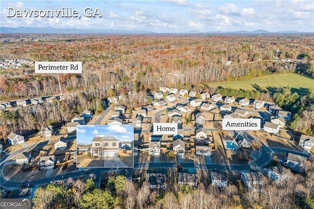303 Orange Cir, Dawsonville, GA 30534 - view of property location with a heavily wooded area, a mountain backdrop, and nearby suburban area