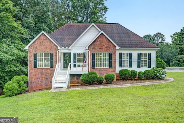 5421 Amherst Way, Flowery Branch, GA 30542 - view of front of home featuring brick siding, a front lawn, and roof with shingles
