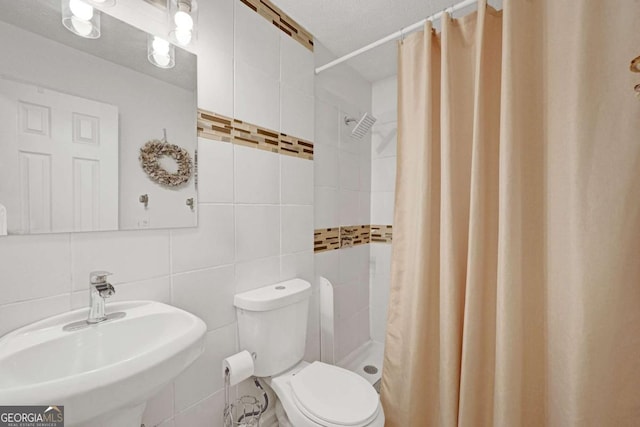 5421 Amherst Way, Flowery Branch, GA 30542 - full bathroom featuring tile walls, a sink, toilet, and a shower stall