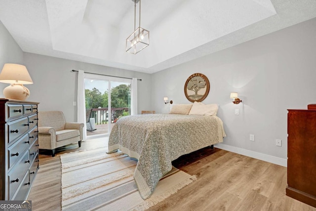 5421 Amherst Way, Flowery Branch, GA 30542 - bedroom with access to outside, light wood-style floors, baseboards, and a raised ceiling