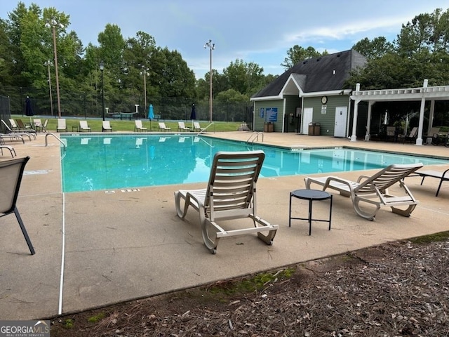 1129 River Green Ct, Mcdonough, GA 30252 - community pool featuring a patio area and view of scattered trees