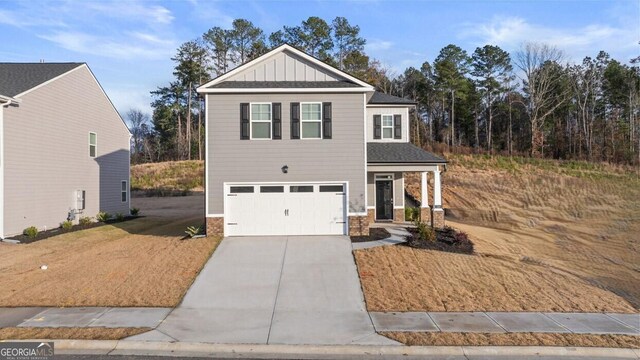 12085 Conrad Cir, Hampton, GA 30228 - view of front of home with a garage, concrete driveway, board and batten siding, brick siding, and a shingled roof