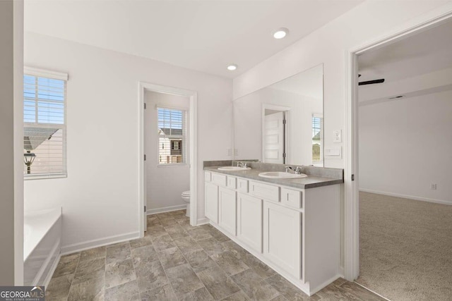 12085 Conrad Cir, Hampton, GA 30228 - bathroom with double vanity, a bath, and recessed lighting