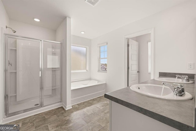 12085 Conrad Cir, Hampton, GA 30228 - full bathroom with a shower stall, a bath, vanity, and recessed lighting