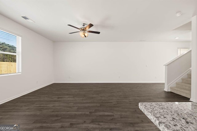 12085 Conrad Cir, Hampton, GA 30228 - empty room featuring ceiling fan, dark wood finished floors, stairs, and a smoke detector