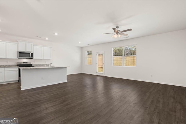 12085 Conrad Cir, Hampton, GA 30228 - unfurnished living room with ceiling fan, recessed lighting, and dark wood-style flooring