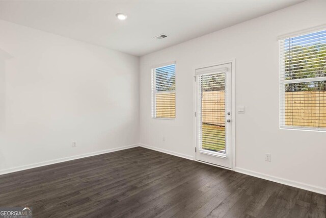12085 Conrad Cir, Hampton, GA 30228 - unfurnished room featuring dark wood-style flooring, healthy amount of natural light, and recessed lighting