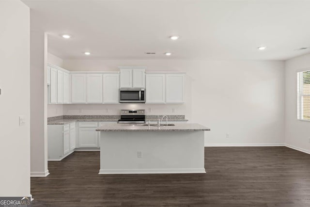 12085 Conrad Cir, Hampton, GA 30228 - kitchen featuring stainless steel appliances, dark wood-style floors, white cabinets, light stone counters, and recessed lighting